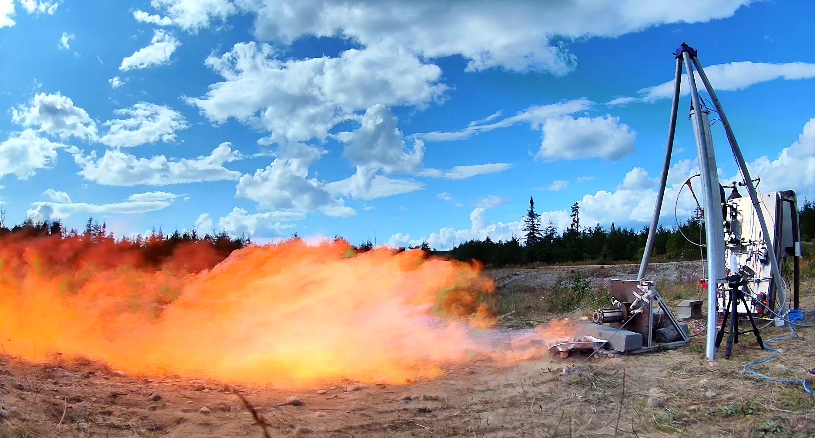 MACH's liquid rocket engine firing at an outdoor test stand